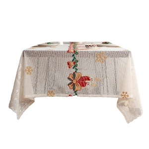 Lace Christmas tablecloth with embroidered red bows, gold bells and festive snowflake patterns