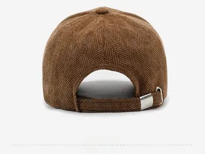 Rear view of brown herringbone baseball cap showing adjustable silver metal buckle