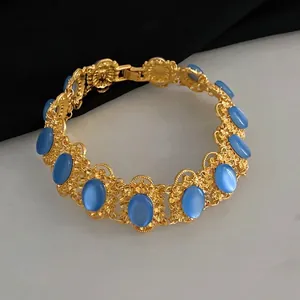 Vintage gold hollow flower link bracelet with oval blue gemstones in a retro royal style
