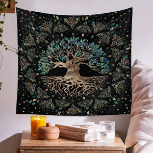 Detail of bohemian tree of life tapestry with celtic knots on a black fabric background