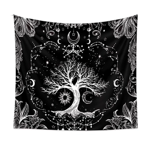 Detail of tree of life tapestry with celestial sun and moon patterns on black fabric