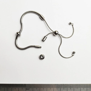 Detail view of silver snake chain bracelet with adjustable slide clasp and threaded end