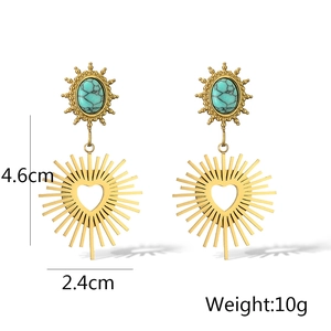 Detailed view of vintage gold sun earrings with turquoise stones and heart pendant