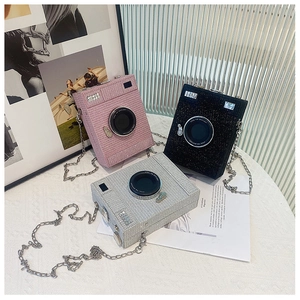 Glittery camera-shaped crossbody bags in pink black and silver with chain straps