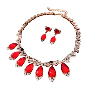 Luxurious gold-plated jewelry set with sparkling crystals and red teardrop pendants