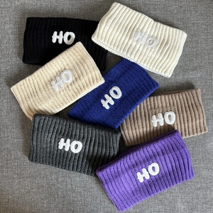 Extra wide knitted sports headbands in multiple colors with white HO towel embroidery