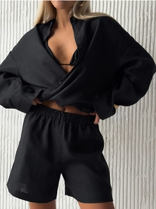 Detail of black linen blend shirt and high-waisted shorts set with natural woven texture