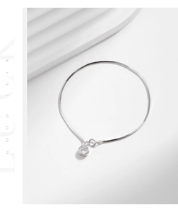 Close-up of elegant S925 silver snake chain bracelet with sparkling round zircon charm