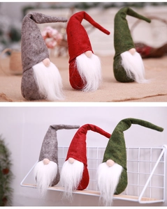 Close-up of three festive Christmas gnomes in grey, red, and green with faux fur beards