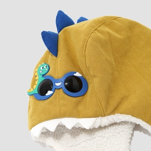 Yellow dinosaur winter trapper hat for toddlers with plush lining and blue goggles detail