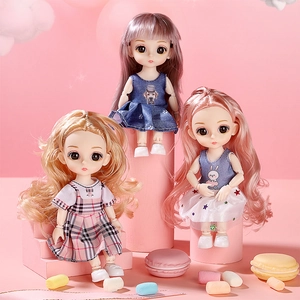 Three posable doll toys with colorful hair and fabric dresses on a pink dreamy background