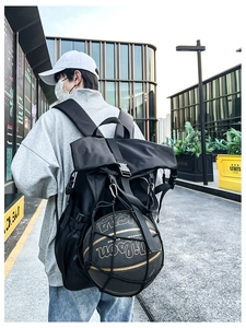 Outdoor street view of a black high-capacity sports backpack with a basketball mesh net