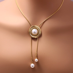 Layered gold stainless steel necklace with sunburst sun texture and white pearl pendant