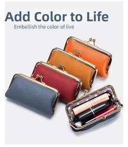 Macro detail of mini leather coin purses in various colors with gold kiss-lock closure
