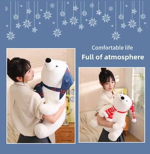 Close-up of white plush polar bear wearing red striped scarf and festive hat