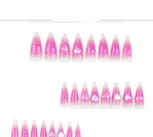 Detail of pink gradient stiletto nails featuring 3D heart motifs and wave patterns