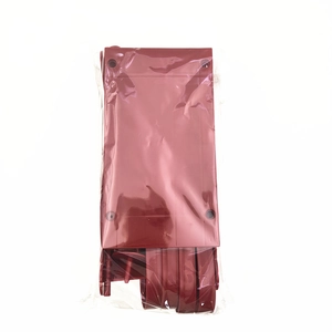 Detail view of a dark red Christmas sleigh ornament accessory in clear plastic packaging