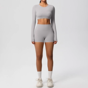 Close-up of light gray long sleeve crop top and high waist yoga shorts set