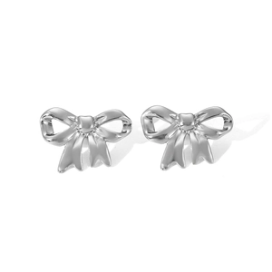 Detailed macro view of silver bow-shaped stud earrings in polished stainless steel