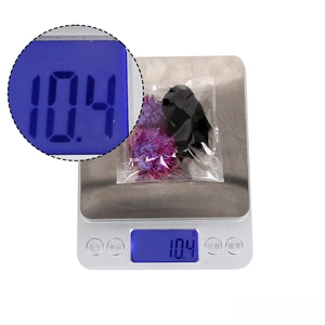 Macro detail of purple glitter spider hair clip showing a total weight of 10.4g on a scale