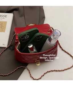Interior view showing the storage capacity of the red quilted chain bag with gold lock