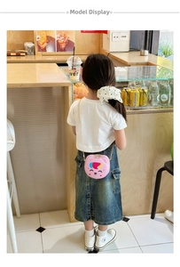 Pink cartoon animal crossbody bag for girls with gold chain strap shown on a young model