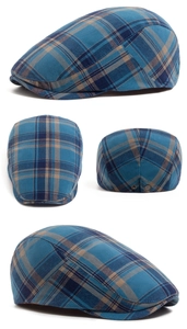 Detail view of plaid flat cap showing blue tartan pattern and metal side buckle adjustment