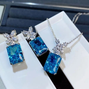 Macro detail of ice blue radiant cut crystal set with silver butterfly accents