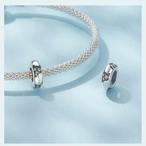 Detail shot of a S925 sterling silver kitten charm showing fine metal texture and S925 hallmark