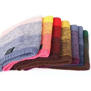 Close-up of winter knit beanie with thick fleece lining and gradient color texture