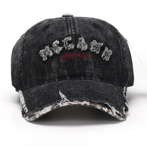 Distressed black wash baseball cap with MCCANN 3D embroidery and vintage frayed edges