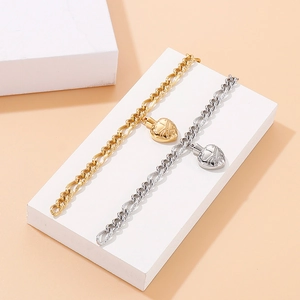 Gold and silver heart pendant stainless steel chain bracelets on display stands