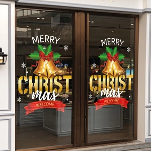 Christmas window stickers with gold bells and Merry Christmas text on a glass door