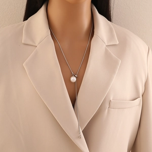 Elegant long silver necklace featuring a white faux pearl pendant for a minimalist look