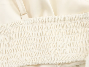 Macro shot of beige smocked bodice with elastic pleats and fine sewing craftsmanship