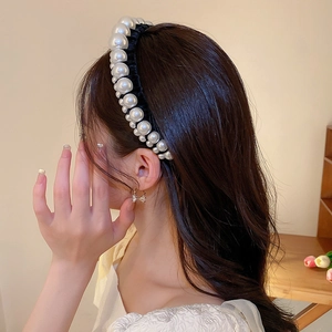 Detail of vintage black velvet headband with alternating cream pearls for high skull top look