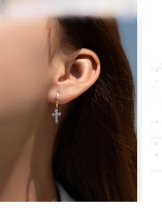 Close-up of S925 silver cross drop earrings with blue opal stones on a model