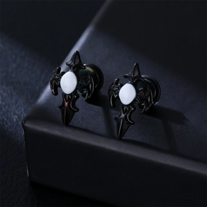 Close-up of black gothic cross stud earrings with matte finish and white stone inlay