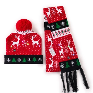 Detail view of red Christmas hat and scarf set with LED ON/OFF switch and reindeer pattern