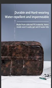 Close-up showing the waterproof PU leather surface with water droplets on brown toiletry bag