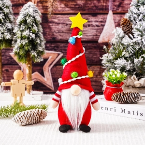 Close-up of a festive Christmas gnome doll with a red star hat and white beard decoration
