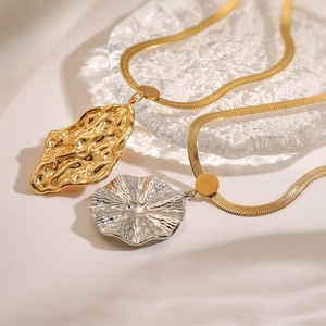 Minimalist snake chain necklace with irregular textured geometric pendants in gold and silver