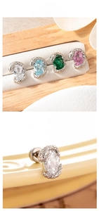 Detailed close-up of serpent-shaped stud earrings with oval-cut colorful zircons