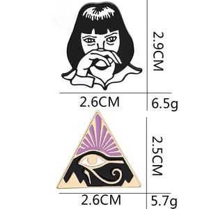 Enamel pins featuring a lonely girl and Egyptian Eye of Horus with size and weight specs