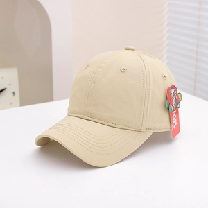 Detailed view of beige cotton canvas baseball cap with classic six-panel design and side tag