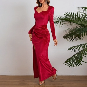 Detail of red velvet long sleeve dress showing elegant square neck and high slit design