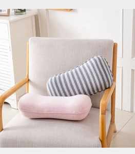Pink and striped memory foam lumbar support pillows on a grey armchair for home office