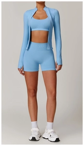 Detailed view of light blue three-piece yoga set including zip jacket and seamless shorts