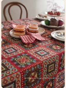 Macro shot of colorful geometric jacquard woven patterns on a festive red tablecloth