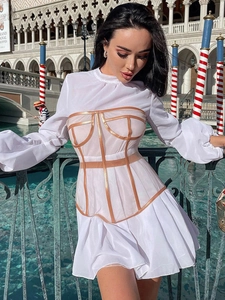 Detail of white mesh dress featuring a translucent champagne waist corset structure
